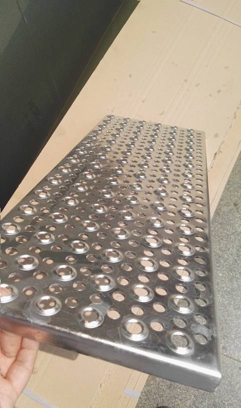 There is one piece of perforated sheet with metal edge, and the round holes are raised and flattened type.