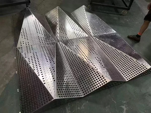 Aluminum carved facade panel with punched perforations folded into 3D forms