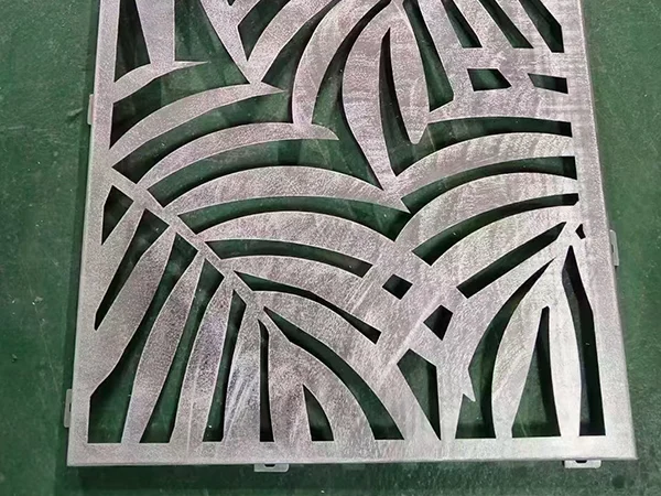 An aluminum carved facade panel with palm leaf design