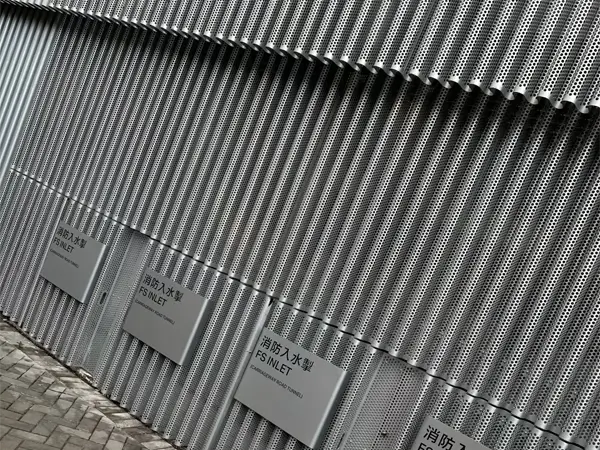 Architectural corrugated perforated panels for fire protection