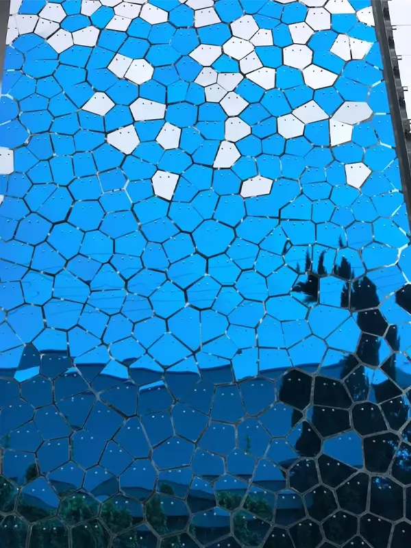 Blue, irregular-shaped mirrored pieces create a pattern, using back plate mounting.