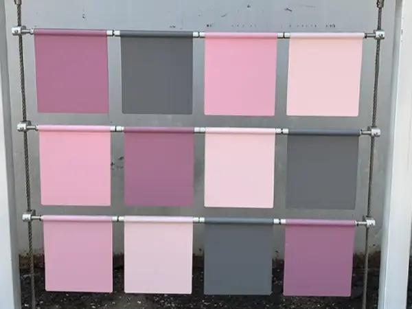 A device with a white frame, multi-colored square plates, using cable hanging mounting