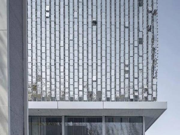 A building with a perforated kinetic facade installed on its exterior