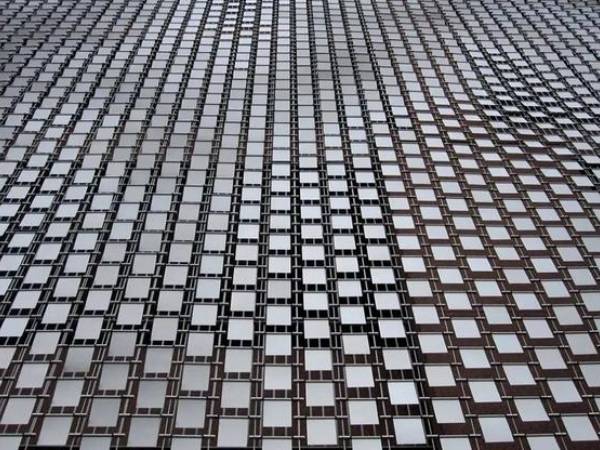 Staggered arrangement of stainless steel perforated kinetic facade