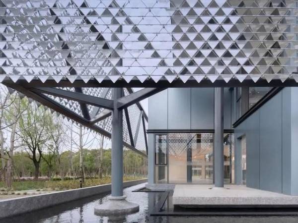 Triangular metal perforated kinetic panels used on the exterior of the building