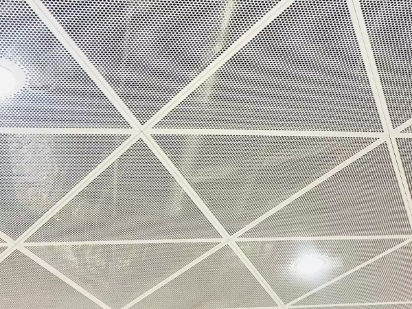 Perforated aluminum sheet used as a commercial district ceiling
