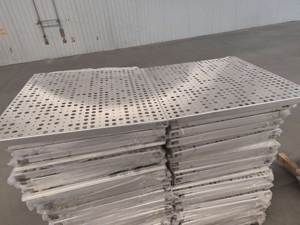 Two stacks of perforated aluminum sheet installation plates