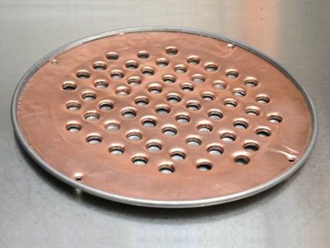 A filter made of perforated brass sheets with round holes