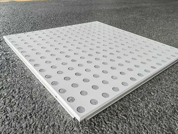 The finished perforated metal acoustic panels with round holes are placed on the floor.