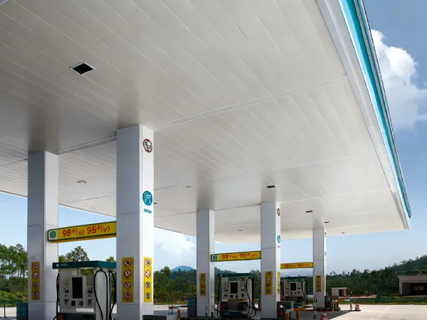 Perforated metal acoustic panels installed above 3 fuel dispensers