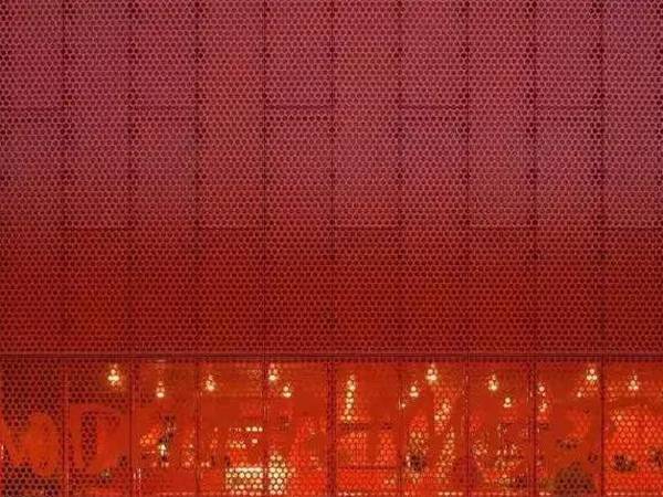 Red round perforated sheets for architectural decoration of restaurant's exterior wall
