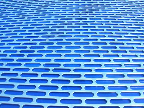 Cladding made of slot hole perforated sheets